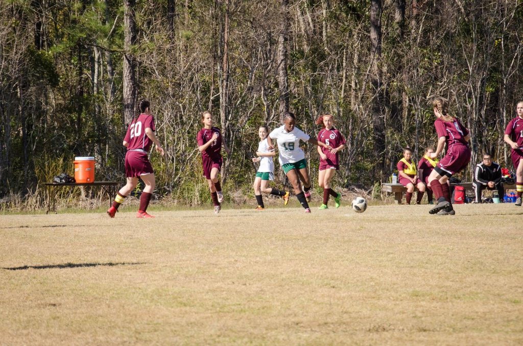 Gramercy Warriors girls soccer player driving the ball upfield during a game